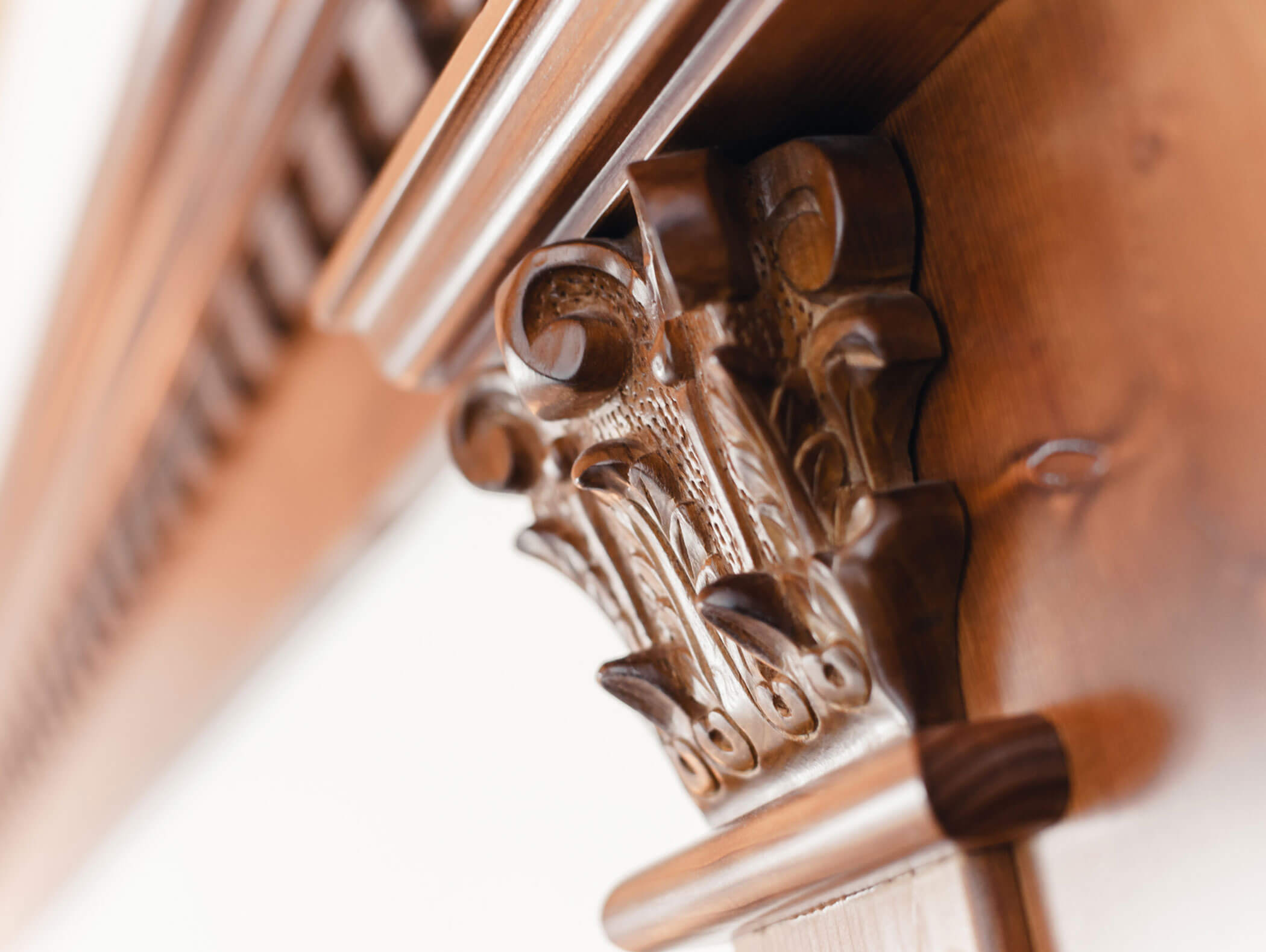 Close-up of an ornate, carved wooden corbel supporting a mantlepiece, with intricate detailing. - Hotel Kristiania