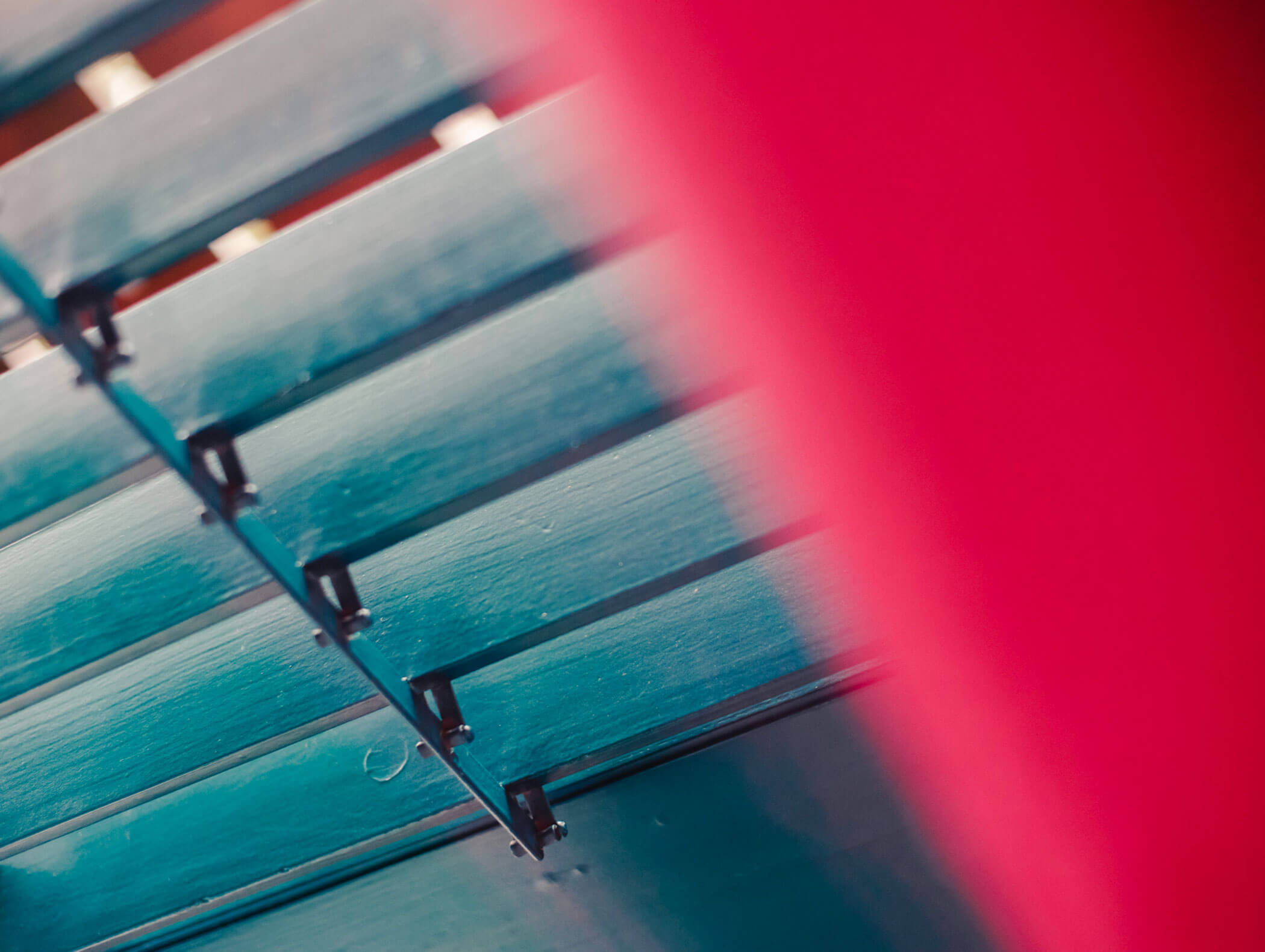 Close-up of blue xylophone bars with a blurred pink object in the foreground. - Hotel Kristiania