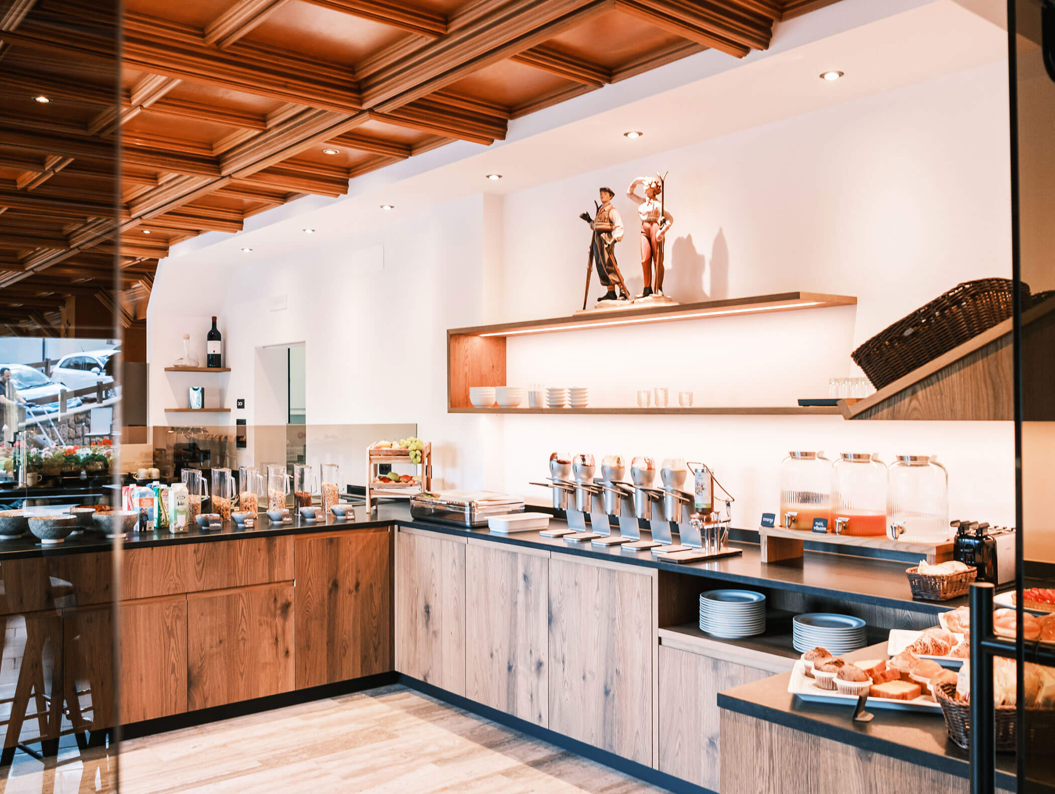 Modern hotel breakfast buffet with cereals, juices, pastries, and a stylish wooden and white interior. - Hotel Kristiania