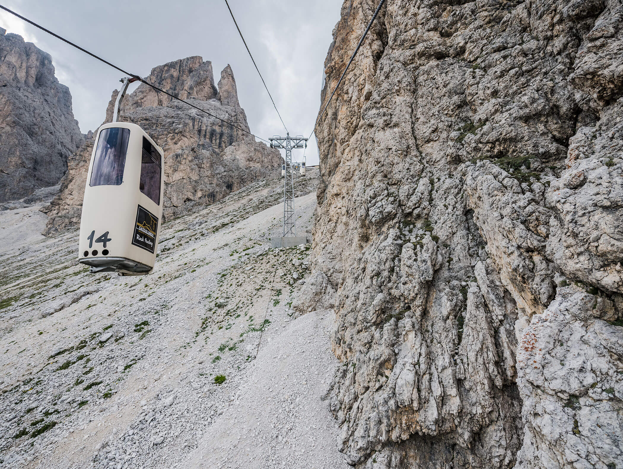 Eine Seilbahn fährt einen felsigen Berghang hinauf, vorbei an schroffen Klippen und steilem Gelände. - Hotel Kristiania